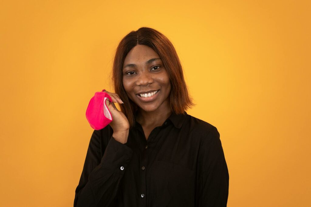 Happy Black woman with pink mask
